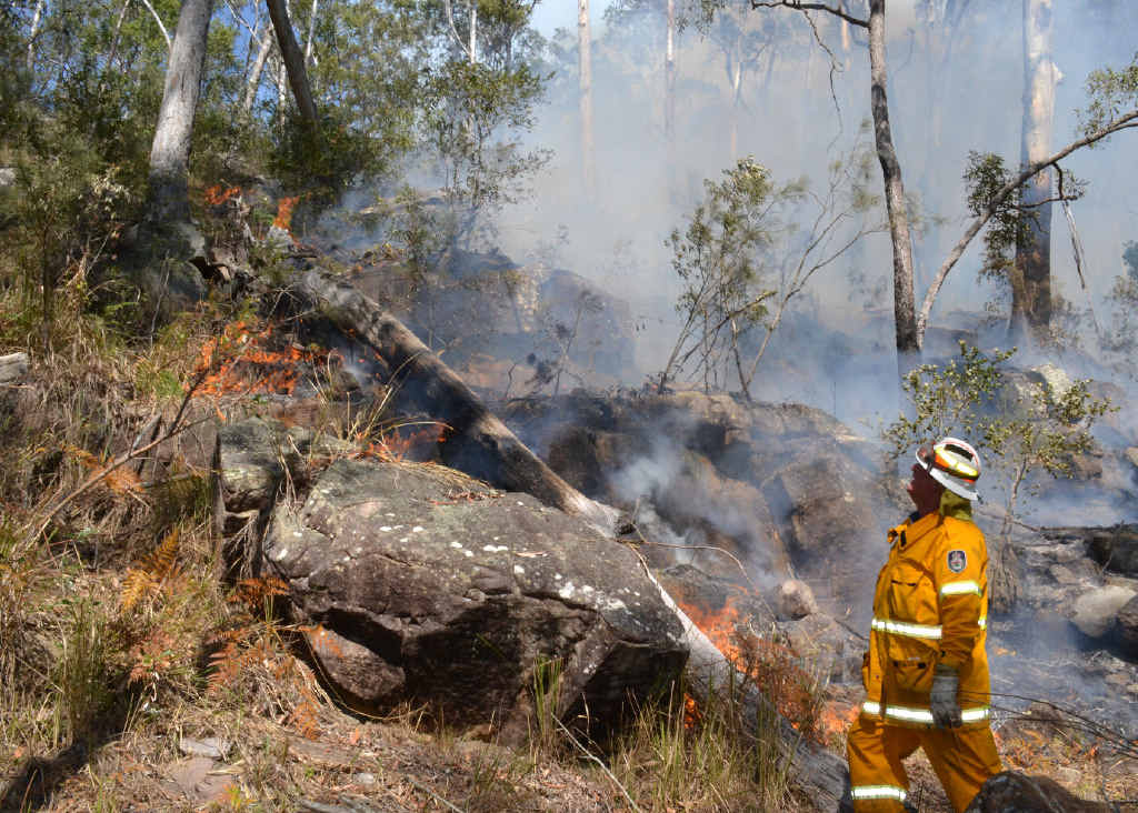 Bob Harbourd, deputy captain of Coutts Crossing Rural Fire Service, surveys a fire on Armidale Rd. Bob Harbourd, deputy captain of Coutts Crossing Rural Fire Service, surveys a fire on Armidale Rd.